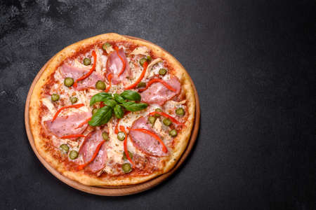Delicious fresh crispy pizza from the oven with ham and Bulgarian pepper. Italian cuisineの写真素材
