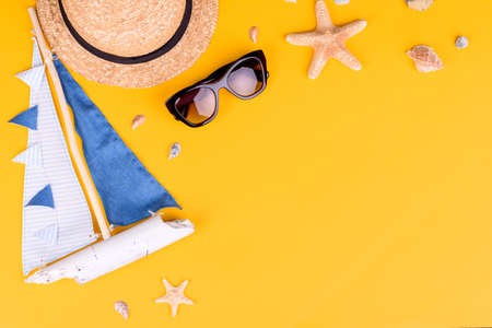 Beach accessories: glasses and hat with shells and sea stars on a colored background. Summer backgroundの写真素材