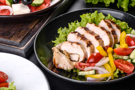 Fresh delicious salad with chicken, tomato, cucumber, onions and greens with olive oil. Summer menu...