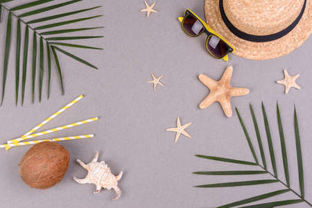 Beach accessories with shells and sea stars on a colored background