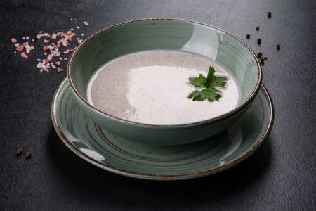Delicious fresh hot mushroom soup in a ceramic plate. First dish, healthy foodの写真素材