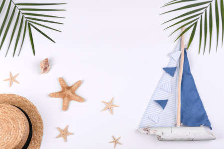 Beach accessories: glasses and hat with shells and sea stars on a white background. Summer backgroundの写真素材