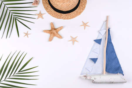 Beach accessories: glasses and hat with shells and sea stars on a white background. Summer...