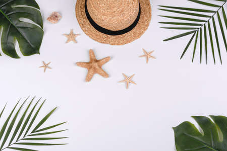 Beach accessories: glasses and hat with shells and sea stars on a white background. Summer backgroundの写真素材