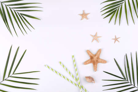 Beach accessories: glasses and hat with shells and sea stars on a white background. Summer...