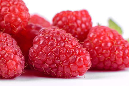 Ripe red raspberries isolated on white background