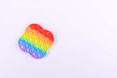 Bright colorful children's toy made of silicone designed to relieve stress on a one-ton paper...