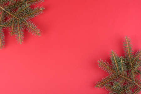 Christmas composition. Christmas red decorations, fir tree branches on red background. Flat lay, top...