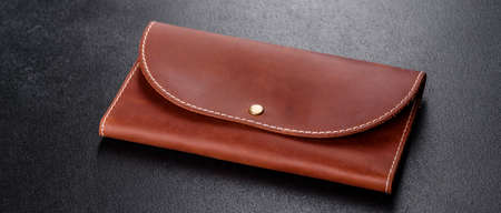 Beautiful leather brown purse made of leather to store paper money and credit cards