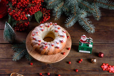 Christmas festive pound cake decorated with cranberries, view from above