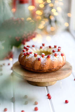 Christmas festive pound cake decorated with cranberries, view from above