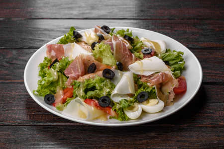 Delicious fresh salad with bacon for the festive table. Preparing for Family Holidayの写真素材