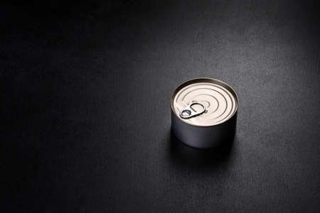 Canned tuna fillet meat in olive oil, on black background, flat layの写真素材