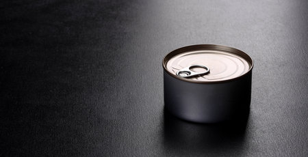 Canned tuna fillet meat in olive oil, on black background, flat layの写真素材