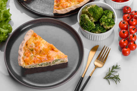 Delicious fresh quiche with broccoli, salmon and cheese. Vegetarian pie with fish and vegetables
