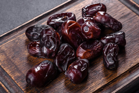 Beautiful delicious dates on a dark concrete background. Tasty healthy fruitの写真素材