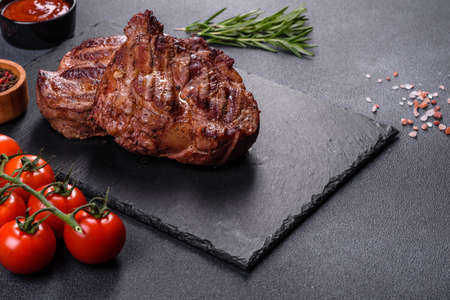 Closeup view of delicious grilled beef medallions served on tableの写真素材