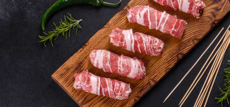 A delicious dish of pork mince wrapped with delicious pieces of bacon. Preparation of chevapchichiの写真素材