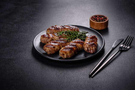 A delicious dish of pork mince wrapped with delicious pieces of bacon. Preparation of chevapchichiの写真素材