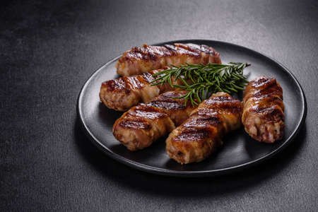 A delicious dish of pork mince wrapped with delicious pieces of bacon. Preparation of chevapchichiの写真素材