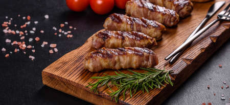 A delicious dish of pork mince wrapped with delicious pieces of bacon. Preparation of chevapchichiの写真素材