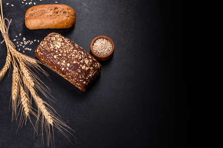 Fresh Bread on black background, top view, copy space. Homemade fresh baked various loafs of wheat and rye breadの写真素材