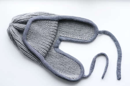 Gray woolen winter knitted hat isolated on white