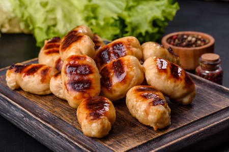 Delicious sausages grilled with spicy sauce. Selective focus