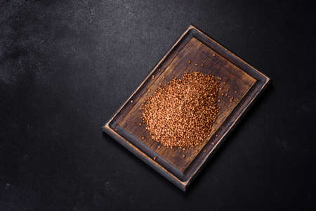 Bio buckwheat cereals raw food background, texture close up. The concept of healthy food, cooking with loveの写真素材