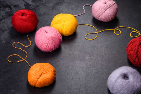 Colorful balls of wool on concrete table. Variety of yarn balls, view from aboveの写真素材