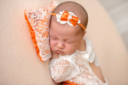 Close-up beautiful sleeping baby girl. Newborn baby girl, asleep on a blanket. A portrait of a beautiful, ten day old, newborn baby girlの写真素材