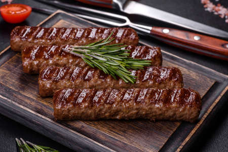 Shish kebab with vegetables on black concrete background
