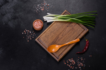 Cut Green onions chives on a cutting board. Dark wooden backgroundの写真素材