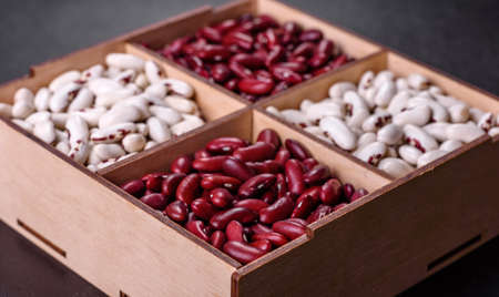 Beans of red and white dry raw beans on a dark concrete background. Cooking Healthy Foodの写真素材