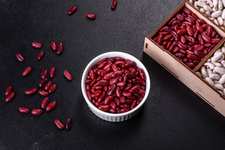Beans of red dry raw beans on a dark concrete background. Cooking Healthy Food
