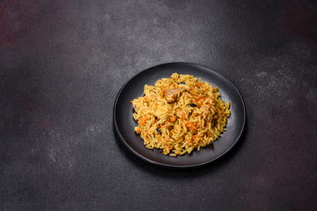 Pilaf with chicken. Traditional oriental hot dish of boiled rice, chicken meat, vegetables and...