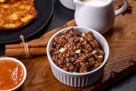 Cereal with chocolate, milk and bread in an egg against a dark concrete background. Delicious...