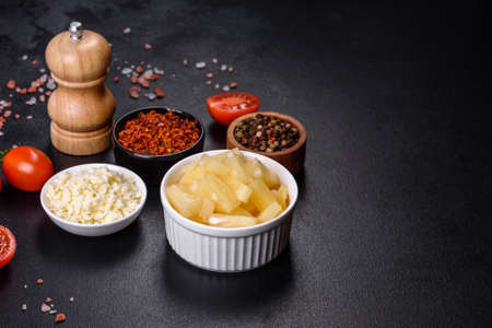 Canned pineapple chunks. Pineapple pieces on dark backgroundの写真素材