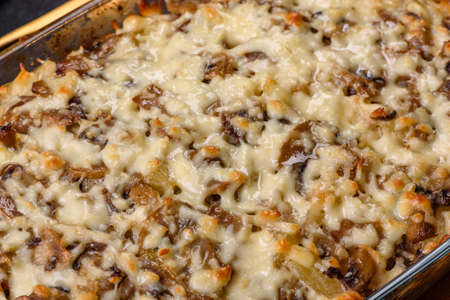 A delicious nutritious dish with meat, mushrooms, vegetables and potatoes, baked in a creamy sauce in an oven. Cooking home-cooked foodの写真素材