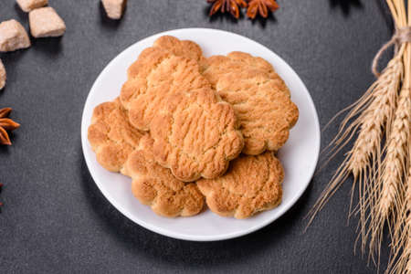 Homemade corn cookies on a dark concrete background. Copy space