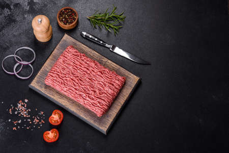 Raw mince beef, ground meat. Black background. Top view. Copy space