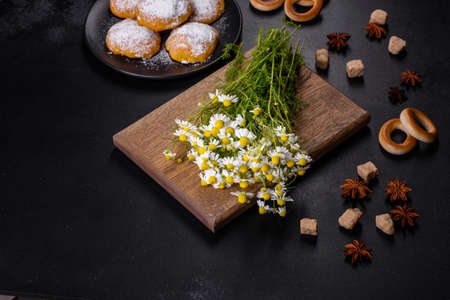 Garden camomile flowers bouquet on a yellow concrete table. Top view flat lay with copy spaceの写真素材