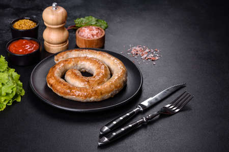 Baked homemade sausage with spices and herbs, close up. Spiral grilled homemade sausageの写真素材