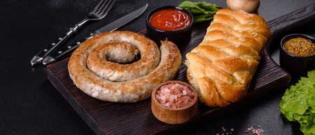 Baked homemade sausage with spices and herbs, close up. Spiral grilled homemade sausage