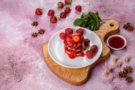 Cottage cheese pancake with strawberry jam on a concrete backgroundの写真素材