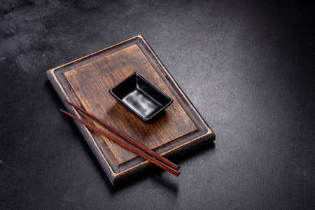 Wooden sushi sticks on a dark concrete background. Japanese Asian cuisineの写真素材