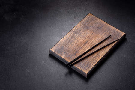 Wooden sushi sticks on a dark concrete background. Japanese Asian cuisineの写真素材