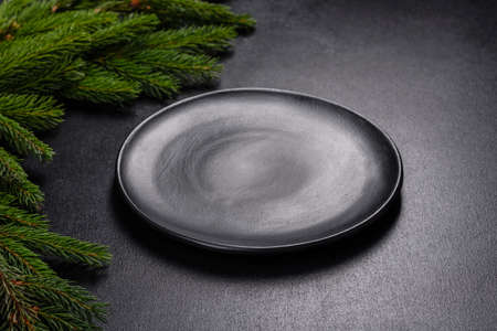 An empty wooden cutting board with wooden cutlery. Preparing the christmas kitchen table for cookingの写真素材