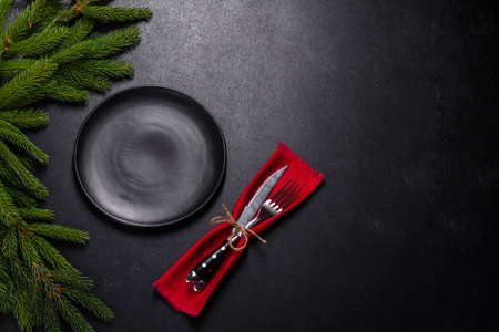 An empty wooden cutting board with wooden cutlery. Preparing the christmas kitchen table for cookingの写真素材