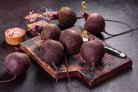 A pile of raw beets on the table. The benefits of vegetables. Harvest and natural productsの写真素材